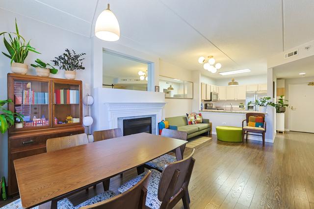 dining room featuring hardwood / wood-style floors, a fireplace, and visible vents