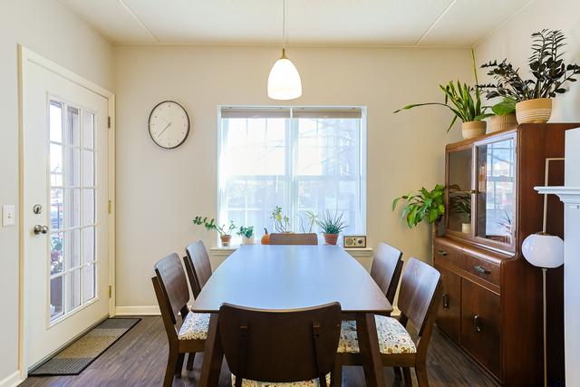 dining area with baseboards and dark wood-type flooring