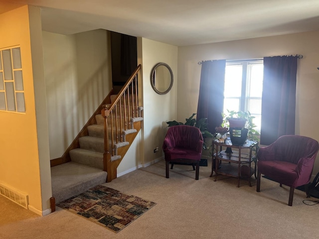 sitting room featuring carpet, visible vents, stairway, and baseboards