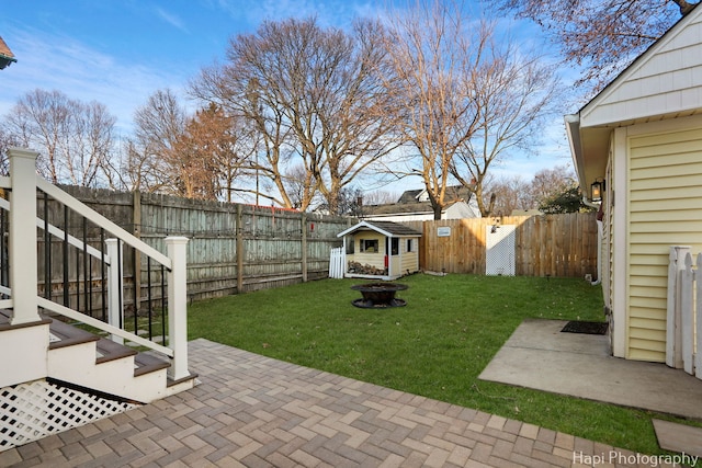 view of yard with an outdoor fire pit, a patio area, and a fenced backyard