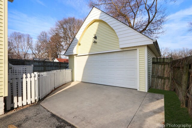 detached garage featuring fence