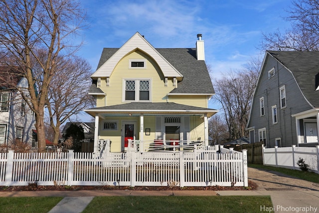 view of front of home featuring a fenced front yard, a chimney, a shingled roof, covered porch, and a gate