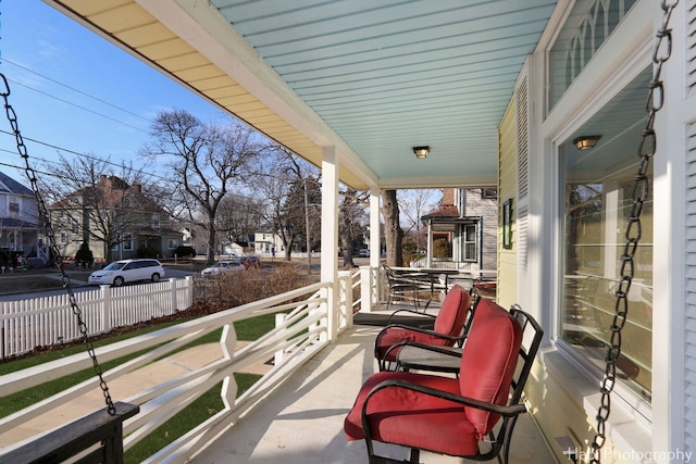 balcony featuring a residential view and a porch