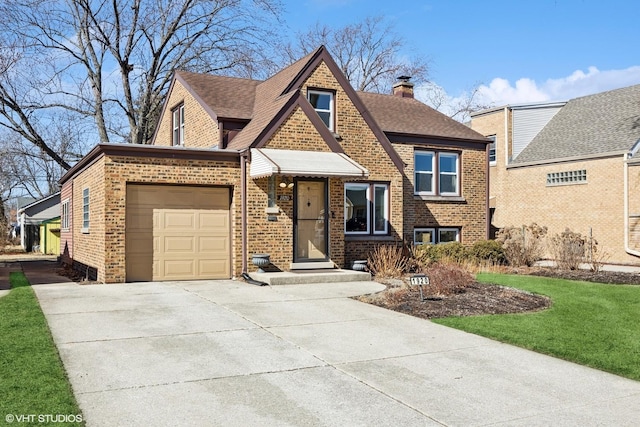 view of front of home featuring a garage, a chimney, concrete driveway, and brick siding