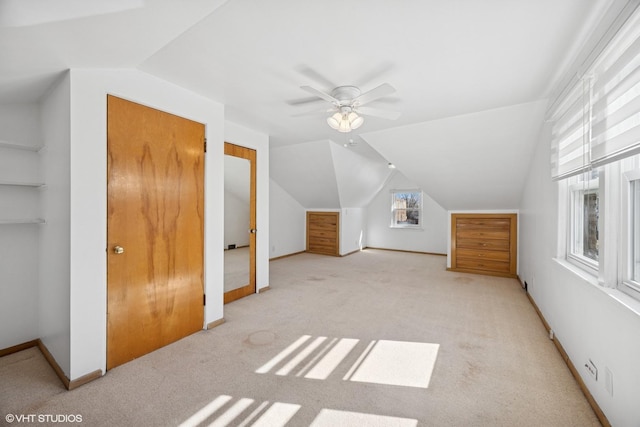 additional living space featuring ceiling fan, carpet, baseboards, and vaulted ceiling