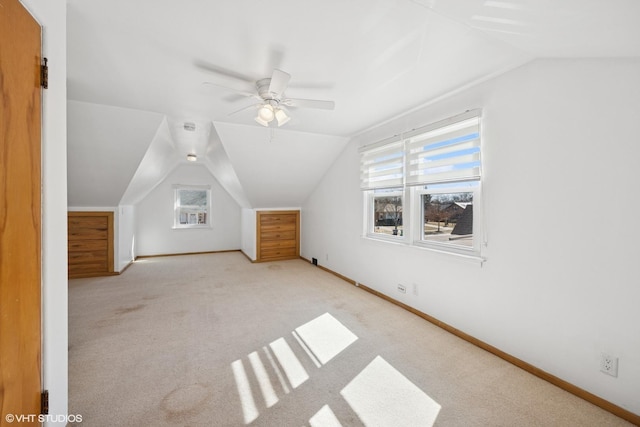 additional living space featuring carpet floors, lofted ceiling, ceiling fan, and baseboards