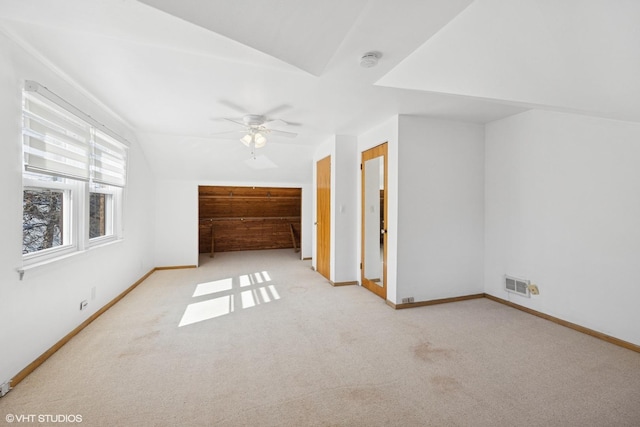 bonus room with carpet floors, visible vents, vaulted ceiling, and baseboards