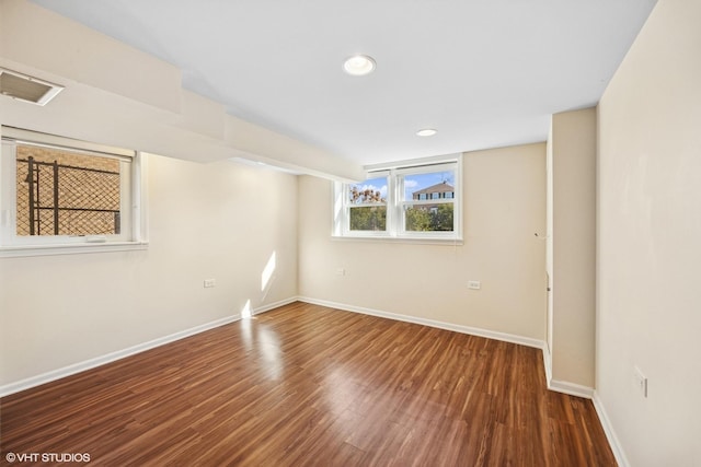 empty room featuring visible vents, baseboards, wood finished floors, and recessed lighting