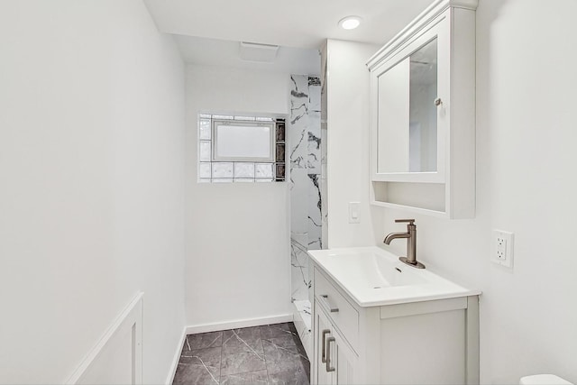 full bath featuring baseboards, marble finish floor, and vanity