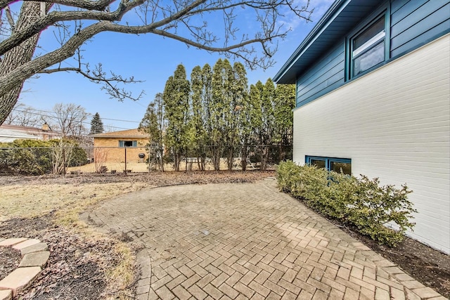 view of patio featuring fence