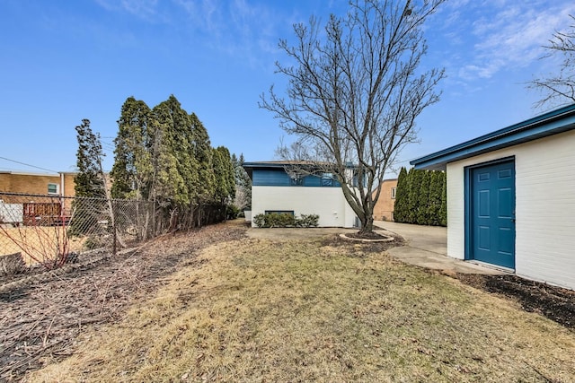 view of yard with an outdoor structure and fence