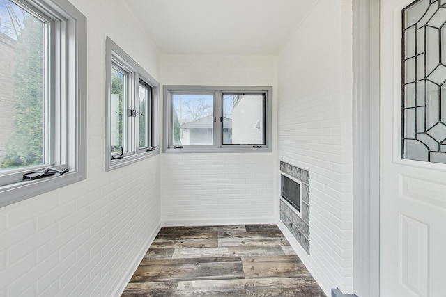 sunroom / solarium with a fireplace