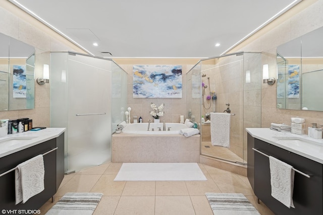 bathroom featuring vanity, tile walls, and a bath