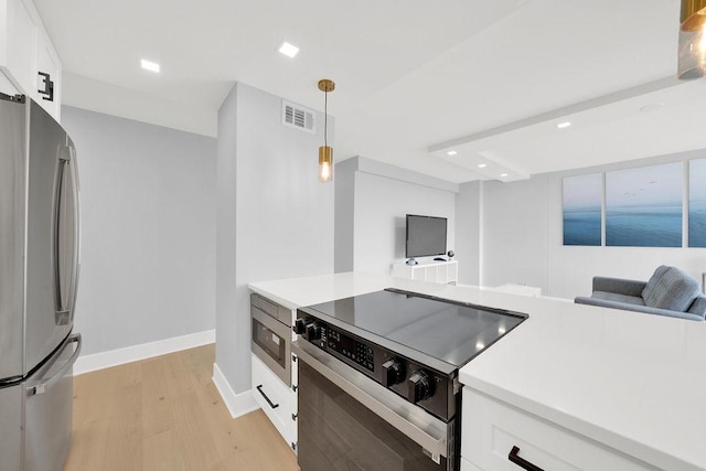 kitchen featuring white cabinetry, appliances with stainless steel finishes, visible vents, and recessed lighting