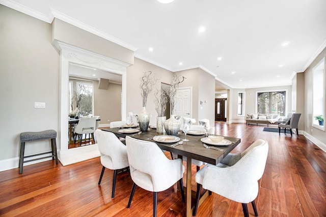 dining space with plenty of natural light, baseboards, and hardwood / wood-style flooring