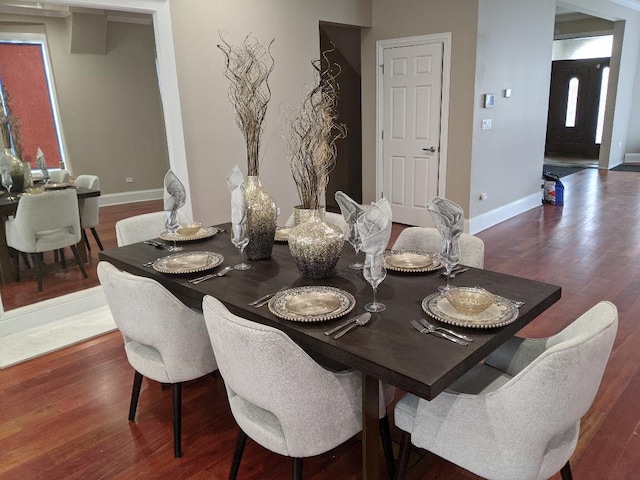 dining room featuring baseboards and wood finished floors