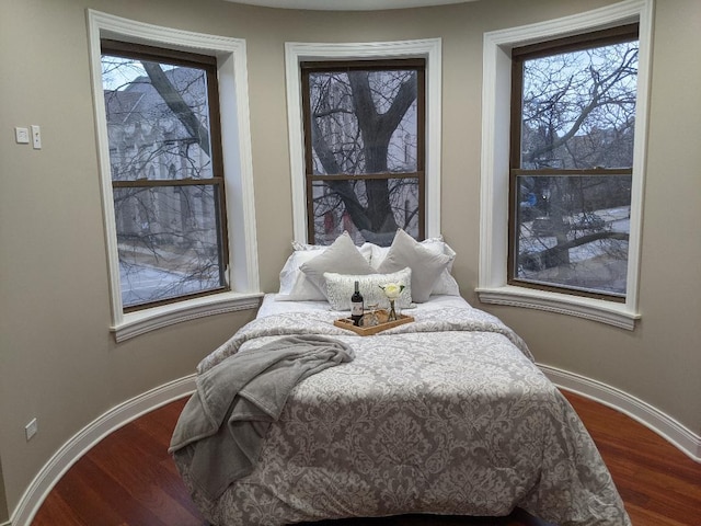 bedroom featuring baseboards and dark wood-style floors