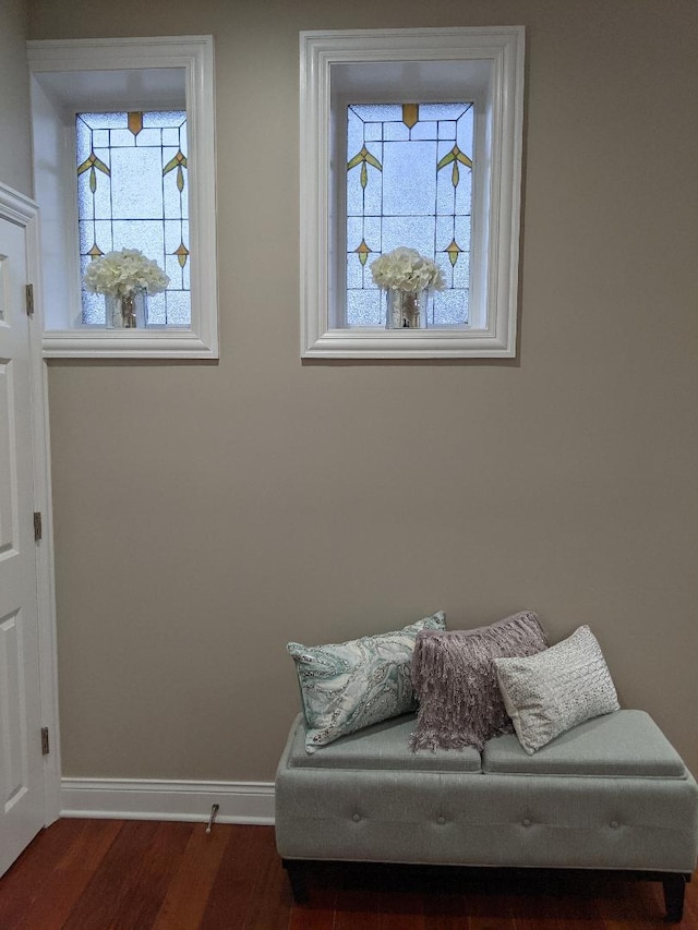 sitting room with plenty of natural light, wood finished floors, and baseboards