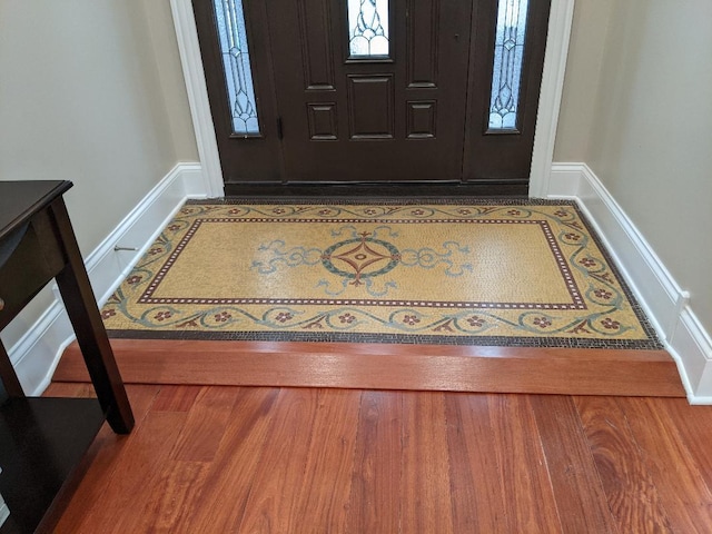 entrance foyer with baseboards and wood finished floors