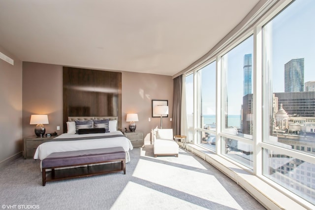 carpeted bedroom featuring baseboards and a view of city