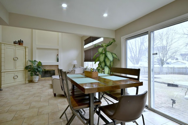 dining room with recessed lighting and a glass covered fireplace