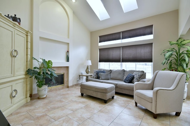 living room with a skylight, a fireplace, high vaulted ceiling, and light tile patterned flooring