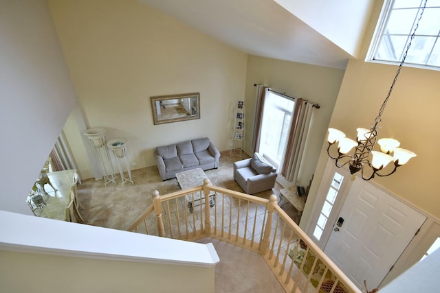 living room with high vaulted ceiling and an inviting chandelier