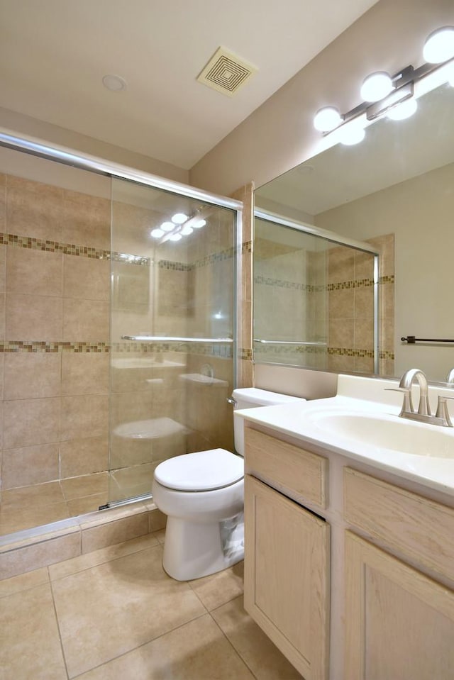 bathroom featuring tile patterned flooring, visible vents, and a shower stall