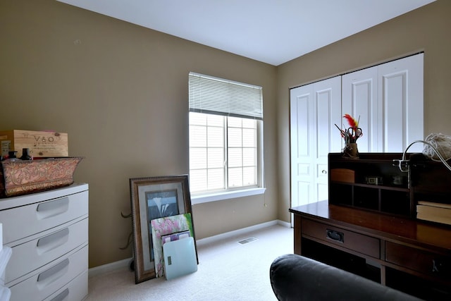 interior space featuring visible vents, light carpet, and baseboards