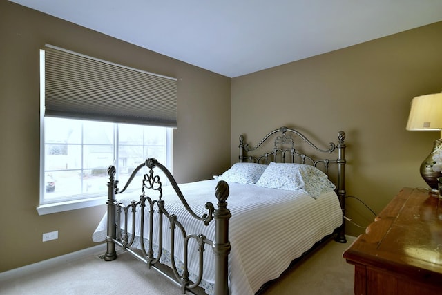 carpeted bedroom featuring baseboards