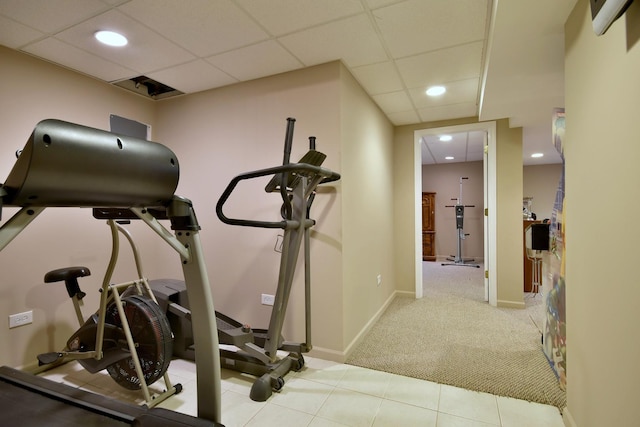 exercise area featuring a paneled ceiling, carpet, baseboards, and recessed lighting