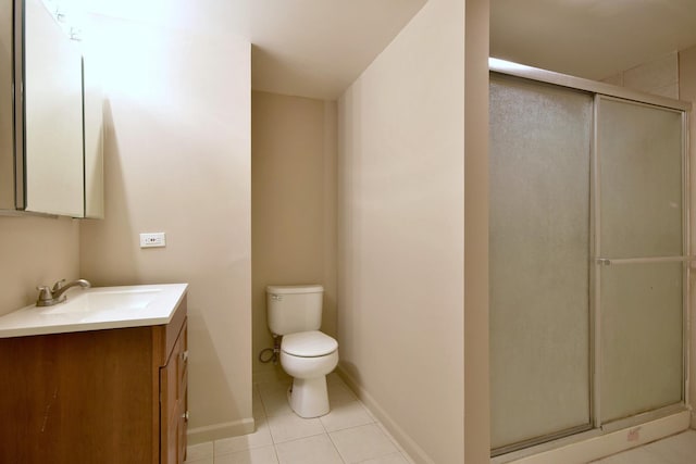 full bath featuring tile patterned flooring, toilet, vanity, baseboards, and a shower stall