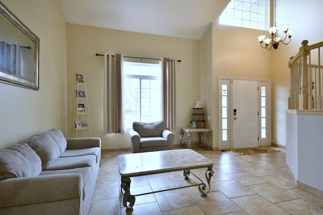 living room featuring a chandelier, baseboards, and light tile patterned floors