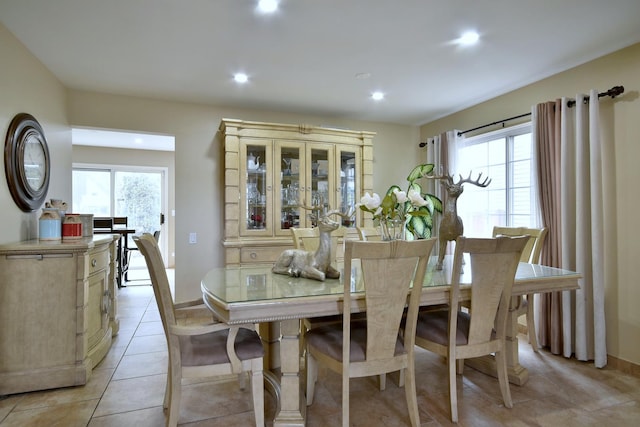 dining space with light tile patterned floors and recessed lighting