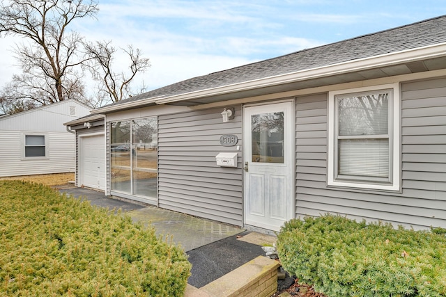 doorway to property featuring roof with shingles