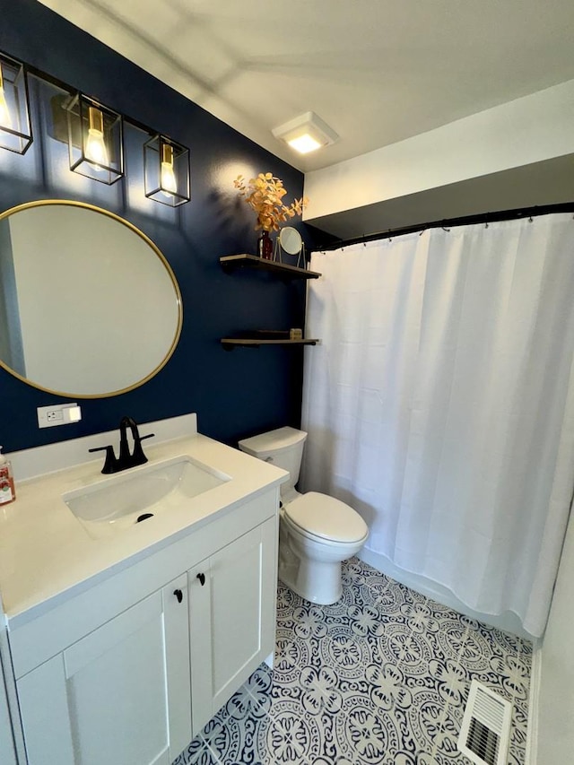 full bath with a shower with shower curtain, vanity, toilet, and tile patterned floors