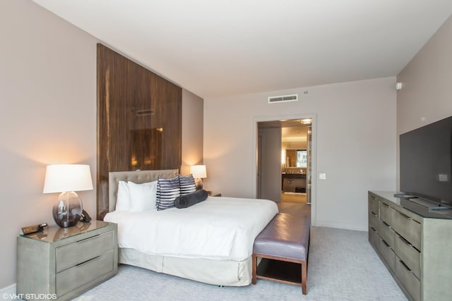 bedroom with visible vents, baseboards, and light colored carpet