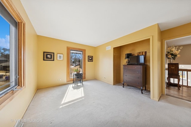 interior space with visible vents, baseboards, and carpet