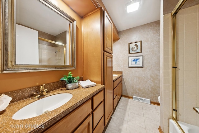 bathroom featuring visible vents, baseboards, vanity, and tile patterned flooring