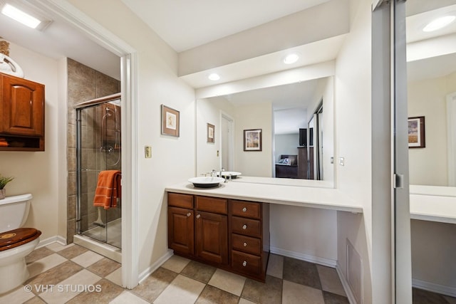 bathroom with vanity, baseboards, recessed lighting, a stall shower, and toilet