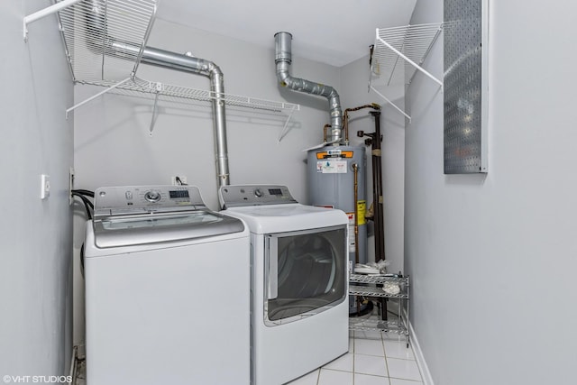 laundry area with gas water heater, laundry area, separate washer and dryer, baseboards, and tile patterned floors