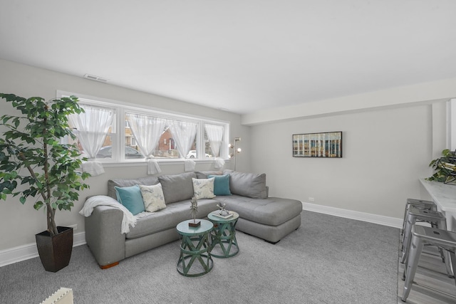 living area featuring carpet flooring, visible vents, and baseboards