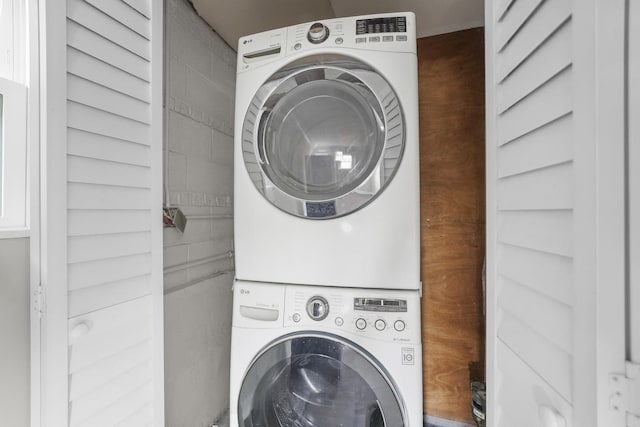 washroom with laundry area and stacked washer / dryer