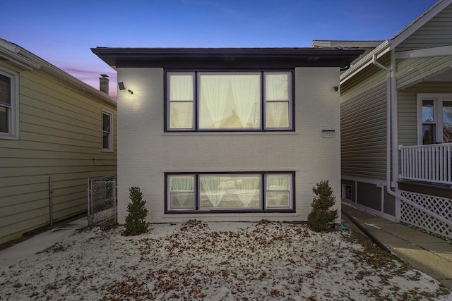 rear view of house featuring brick siding