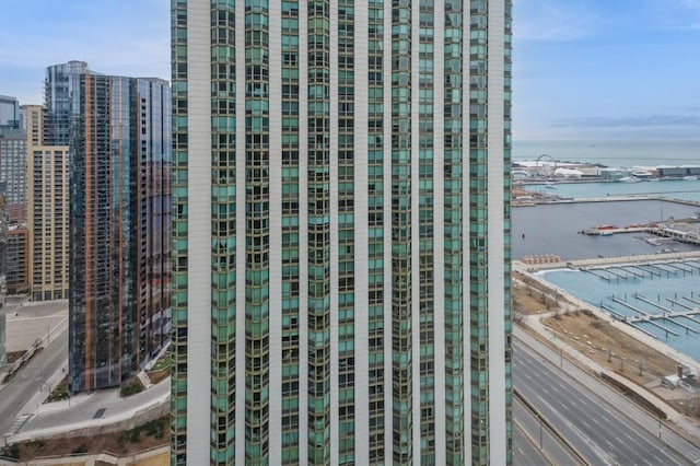 view of building exterior featuring a water view and a view of city