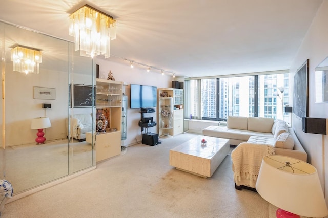 carpeted living area featuring a notable chandelier