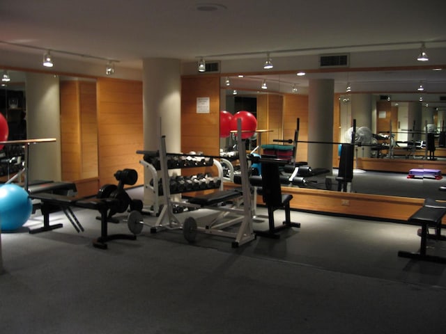 workout area with track lighting and visible vents