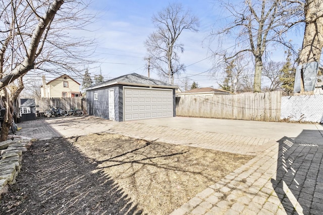 detached garage featuring fence