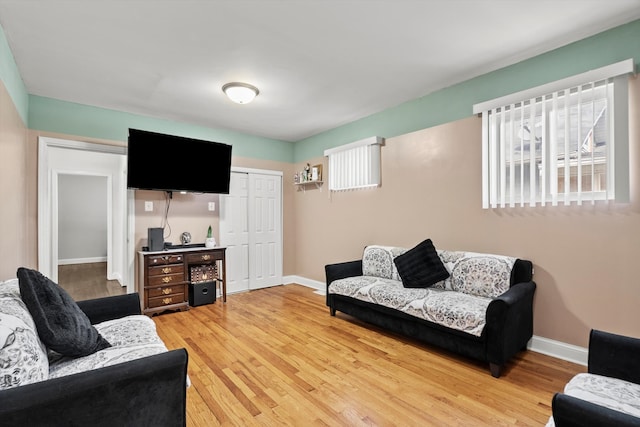 living area featuring light wood-style flooring and baseboards