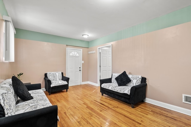 living area featuring light wood-style floors and baseboards